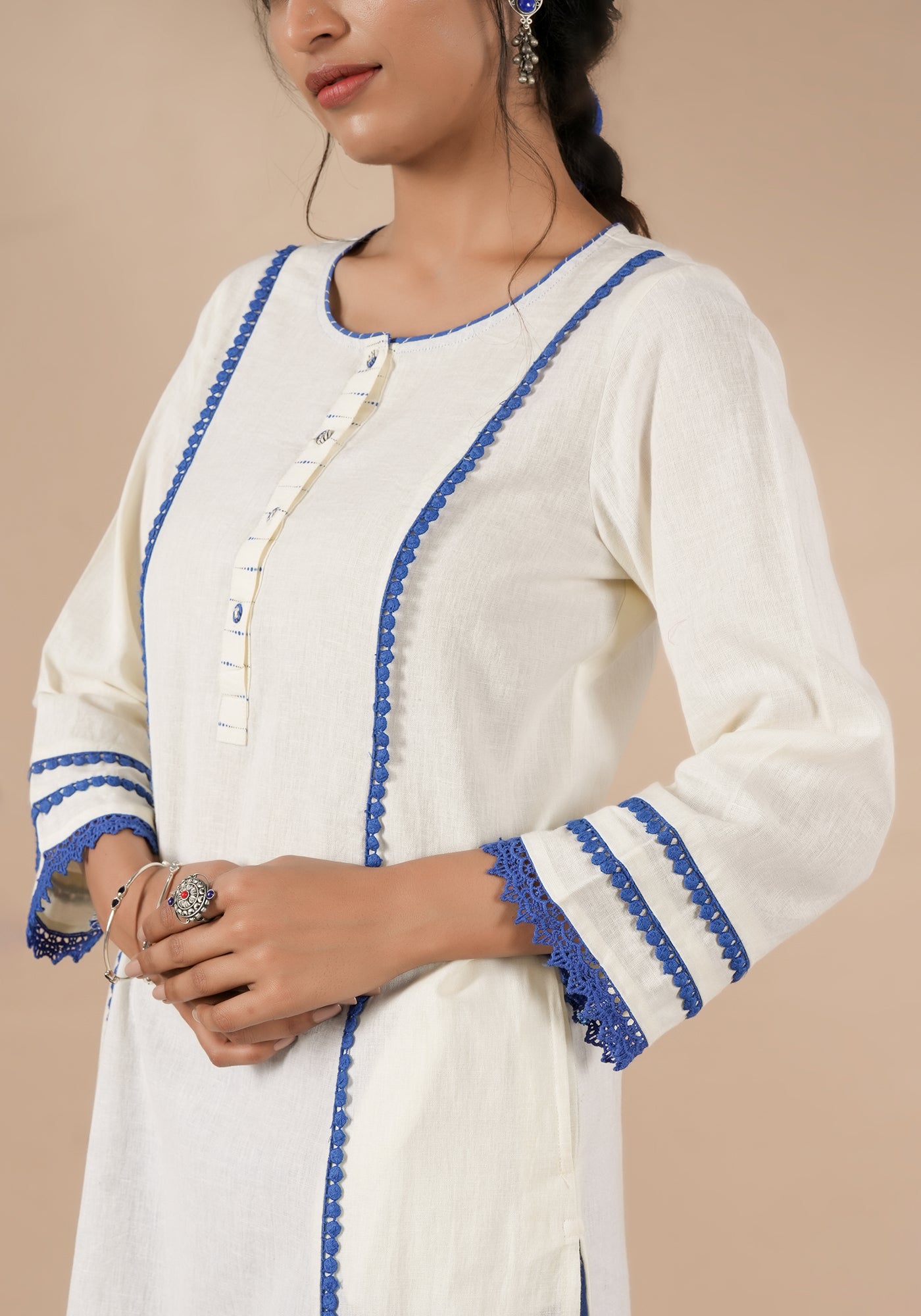 BINDU SOILD OFF WHITE KURTA WITH BLUE DETAILS